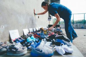 student organizing shoes for donation