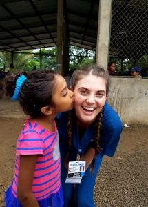 child kissing Bellin student on cheek