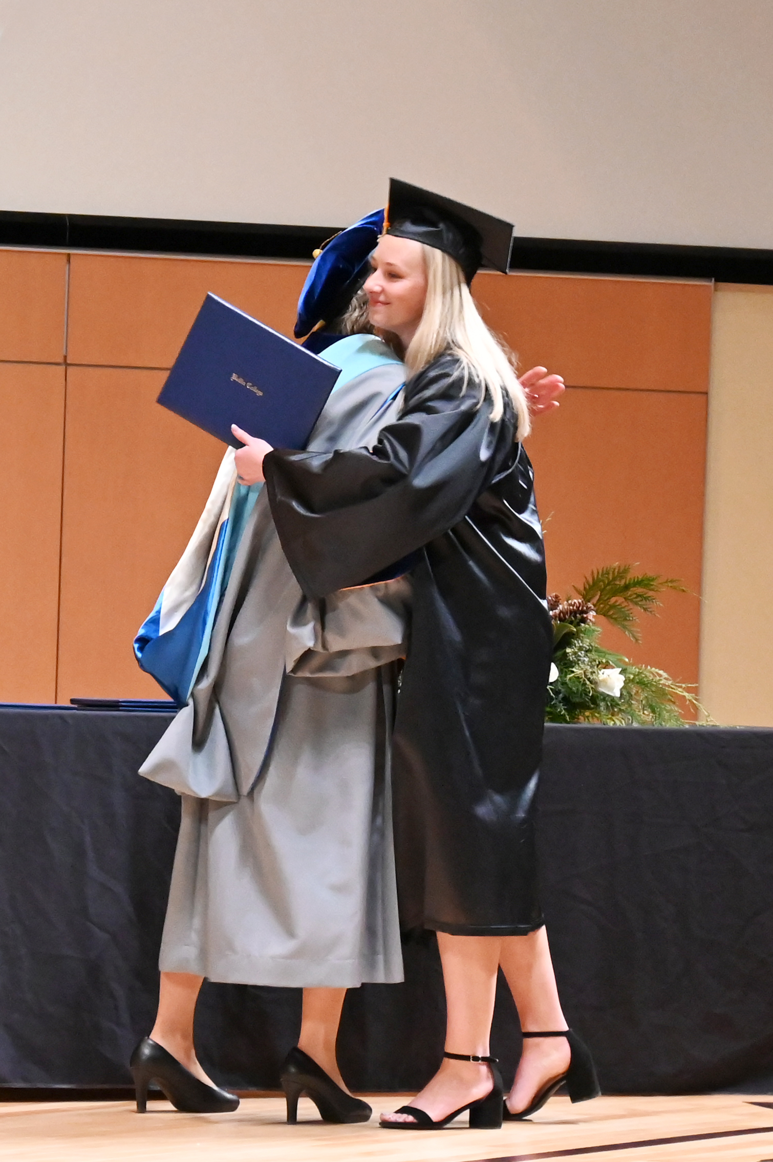 President Connie Boerst hugs female .graduate