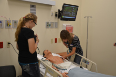 Two students practicing with a simulation  Manikin