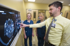 Faculty explaining to students what they are seeing on xray lightbox